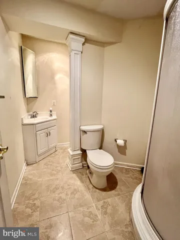 a bathroom with a toilet sink and a mirror