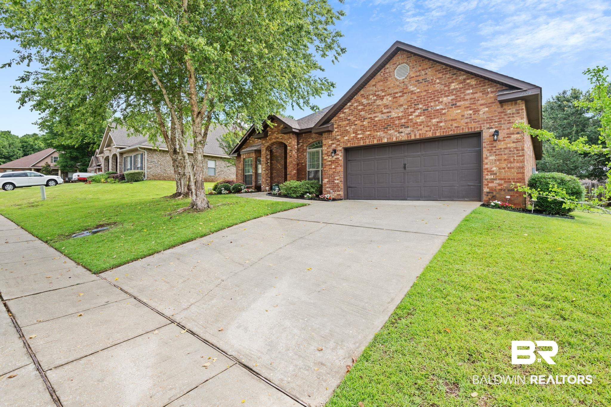 2554 Masters Court Mobile, AL 36618 - Photo 3 of 35 View of front of property featuring brick siding, a front yard, an attached garage, and driveway