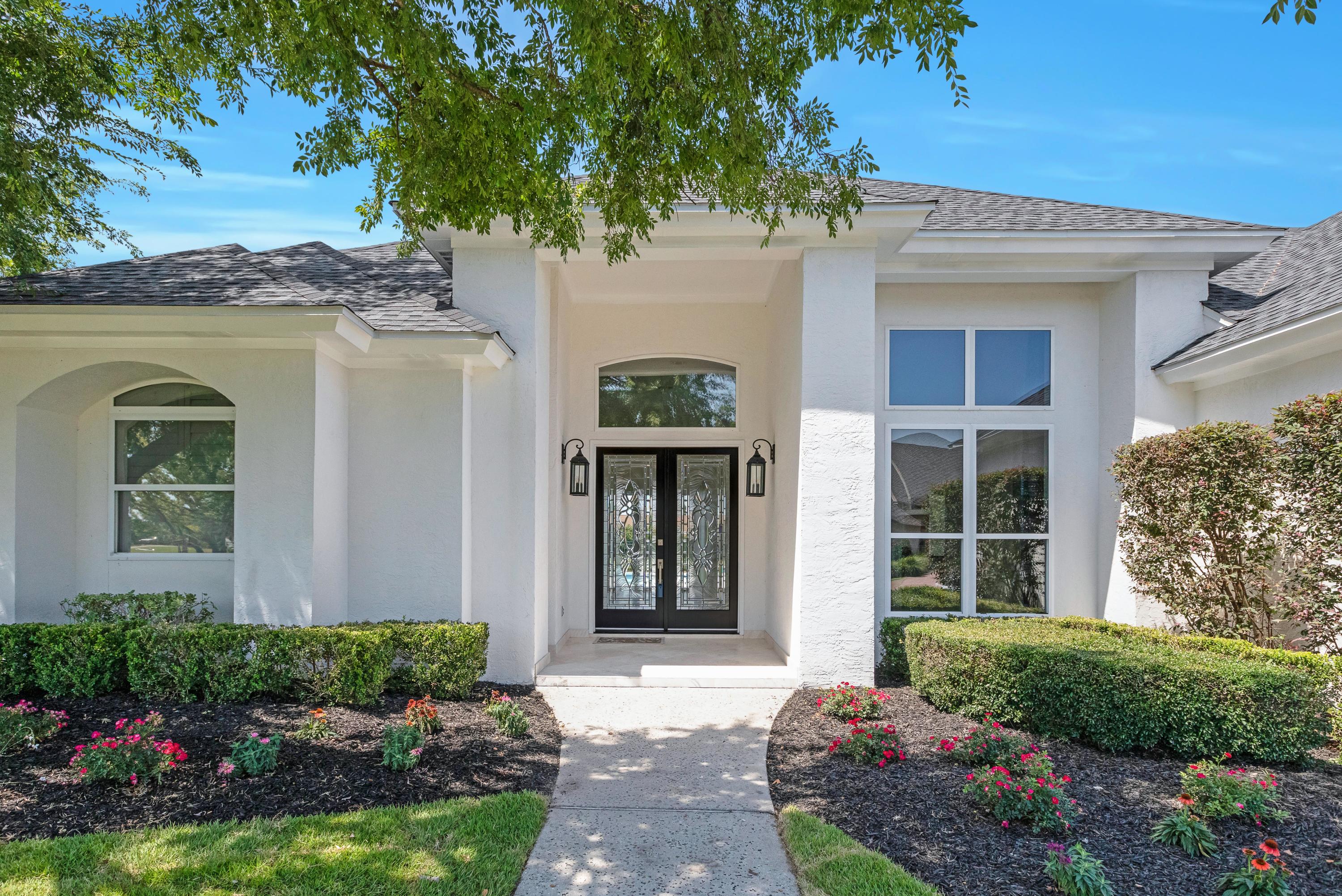 3606 Dragon's Ridge Road Panama City Beach, FL 32408 - Photo 3 of 49 a front view of a house with a garden