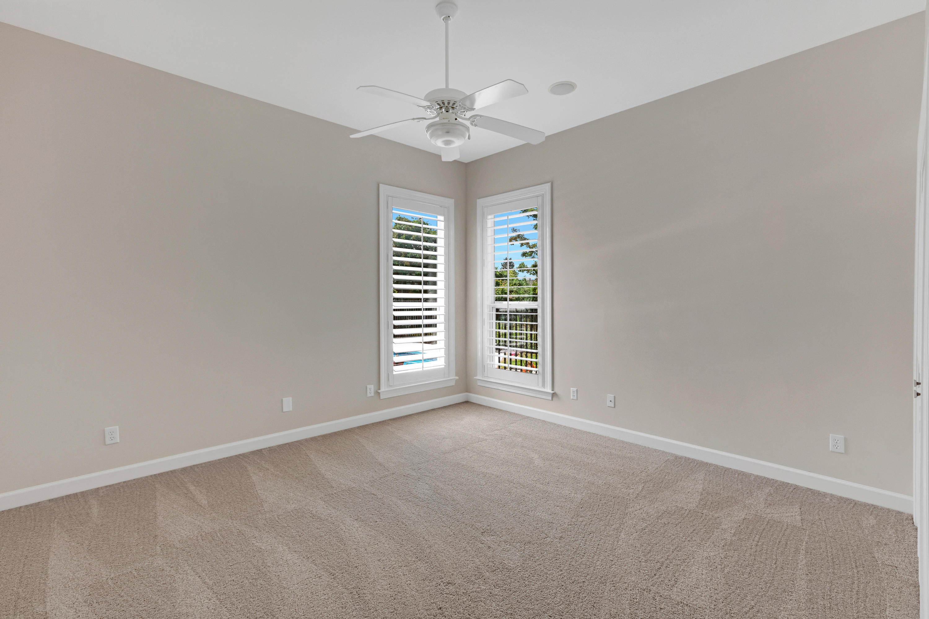 3606 Dragon's Ridge Road Panama City Beach, FL 32408 - Photo 32 of 49 an empty room with windows and ceiling fan