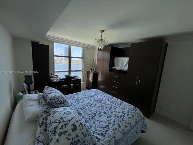 a bedroom with a large bed and a dresser