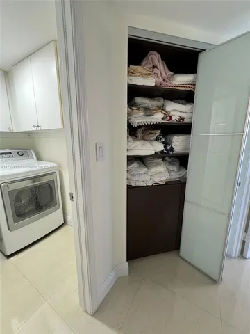 a kitchen with stainless steel appliances granite countertop a refrigerator a sink and blue cabinets