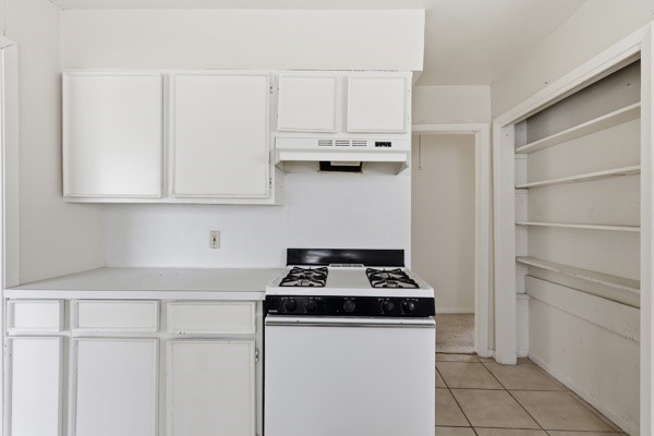 1655 Hawthorne Street Houston, TX 77006 - Photo 22 of 39 a kitchen with granite countertop white cabinets and white appliances