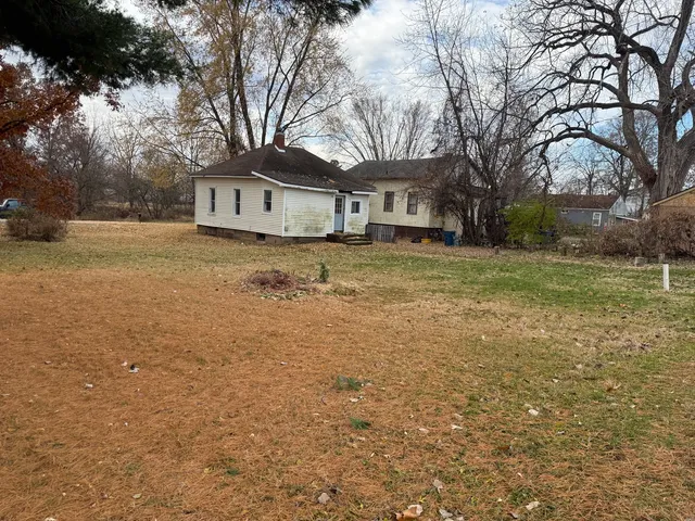 a house that has a tree in front of it