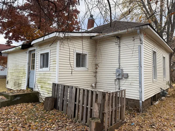 a side view of a house with a yard