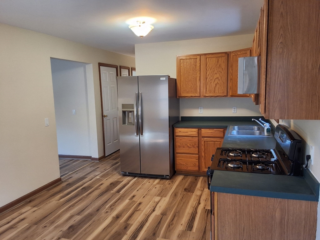 103 Barre Road Oakham, MA 01068 - Photo 14 of 26 a kitchen with a refrigerator stove and cabinets