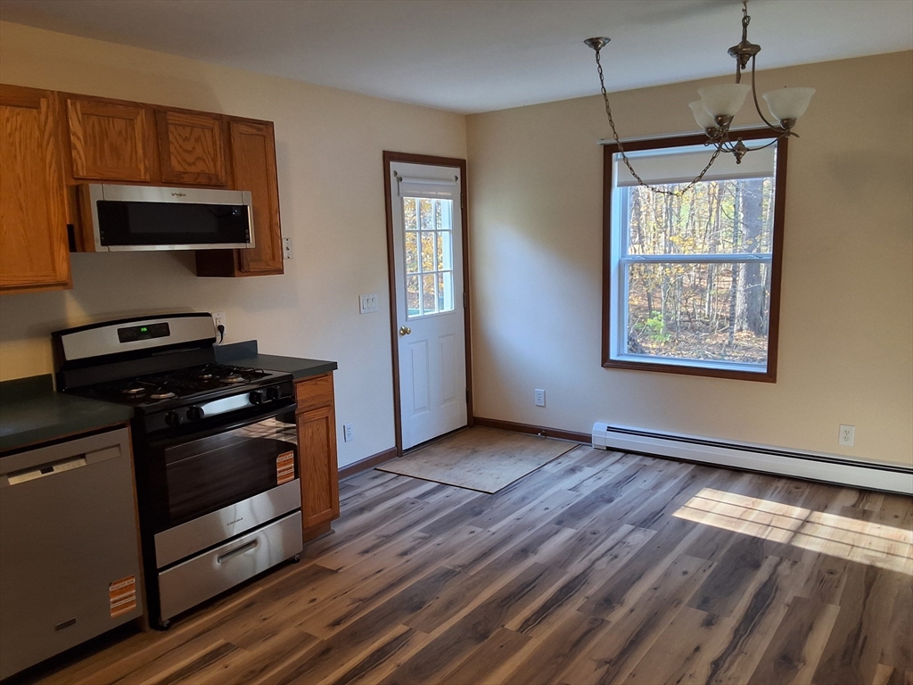 103 Barre Road Oakham, MA 01068 - Photo 15 of 26 a kitchen with stainless steel appliances granite countertop a stove a sink and a microwave