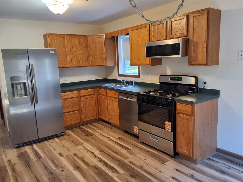 103 Barre Road Oakham, MA 01068 - Photo 16 of 26 a kitchen with stainless steel appliances granite countertop a stove a sink and a refrigerator