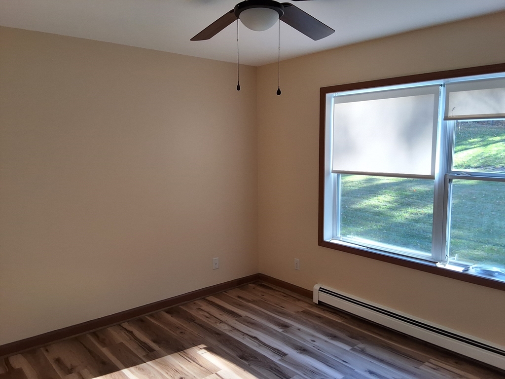 103 Barre Road Oakham, MA 01068 - Photo 19 of 26 a view of an empty room with wooden floor and a window