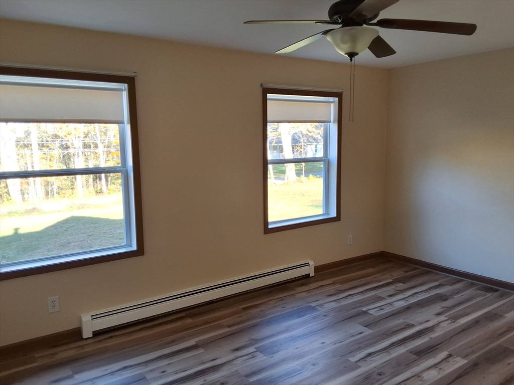 103 Barre Road Oakham, MA 01068 - Photo 20 of 26 a view of an empty room with wooden floor and a window