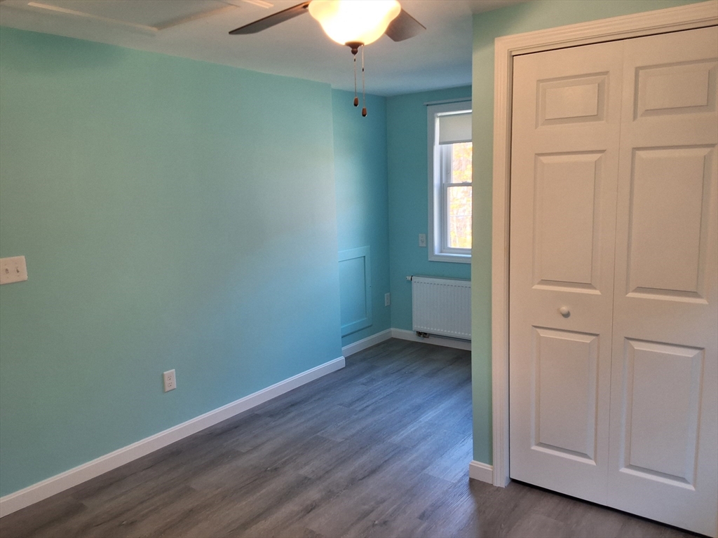 103 Barre Road Oakham, MA 01068 - Photo 26 of 26 an empty room with wooden floor and windows