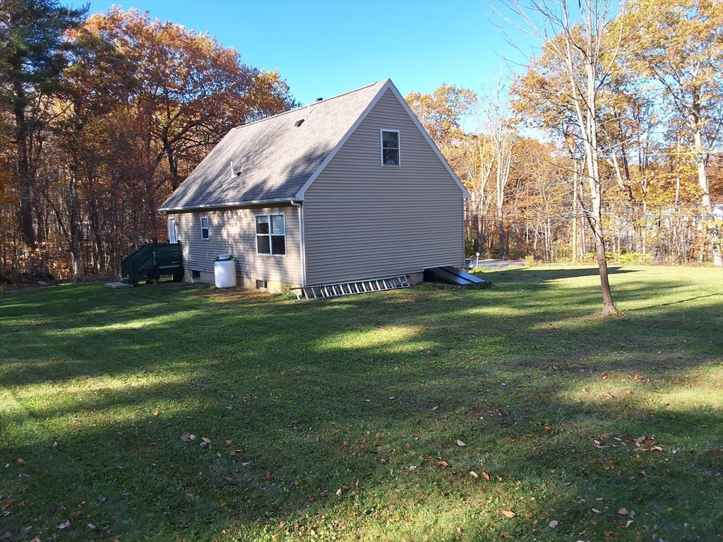 103 Barre Road Oakham, MA 01068 - Photo 5 of 26 a backyard of a house with lots of green space