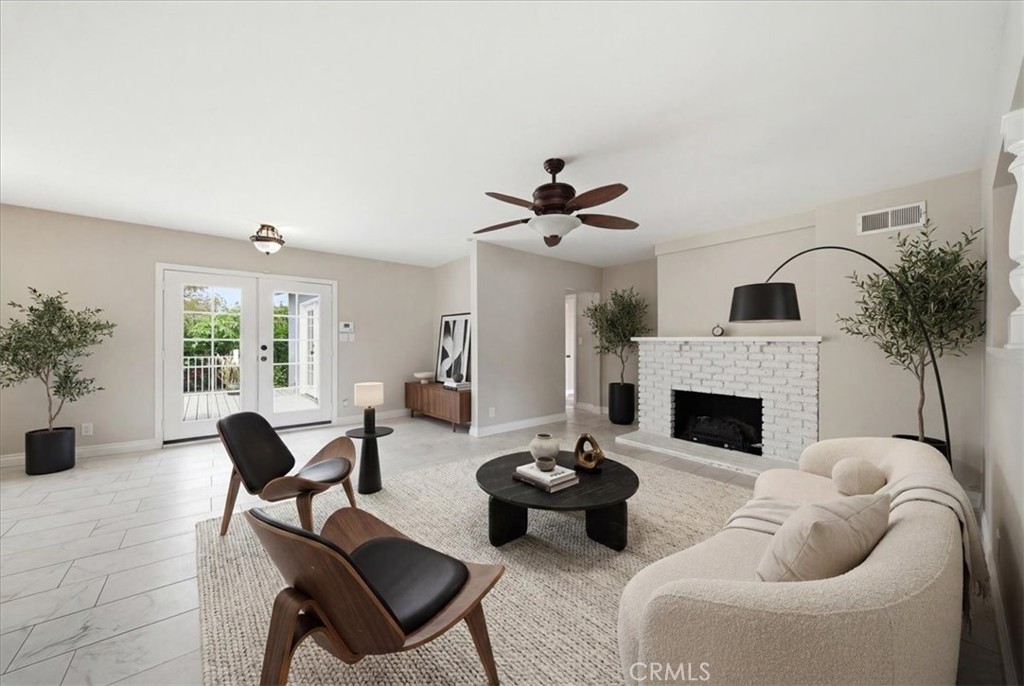 6481 Dos Rios Road Downey, CA 90240 - Photo 3 of 27 a living room with furniture potted plant and a fireplace