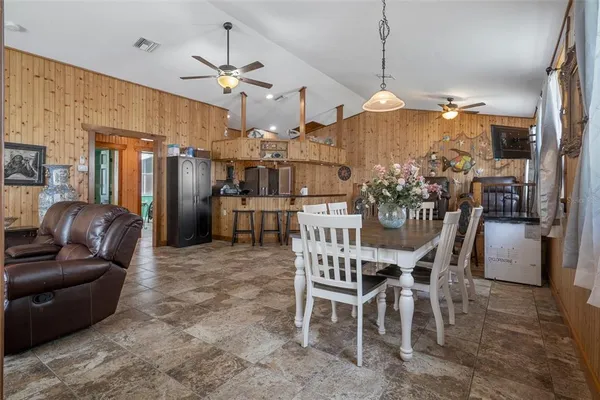 a kitchen with refrigerator a table and chairs
