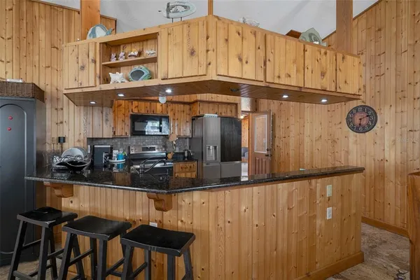a kitchen with lots of counter top space and refrigerator