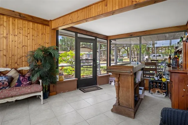 a view of a porch with chairs and backyard