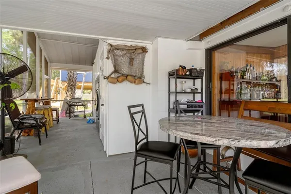 a view of a house with backyard porch and sitting area
