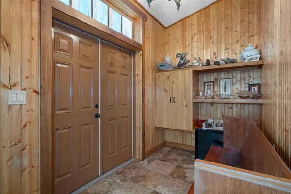 a view of a livingroom with furniture and a hallway