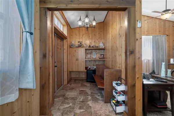 a living room with furniture a couch and a chandelier
