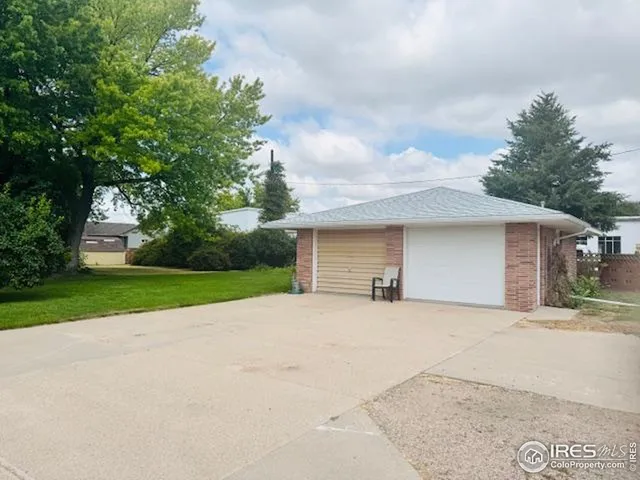a view of a house with a yard and garage