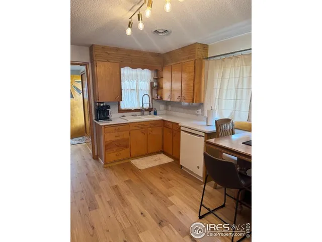 a kitchen with a sink cabinets and window