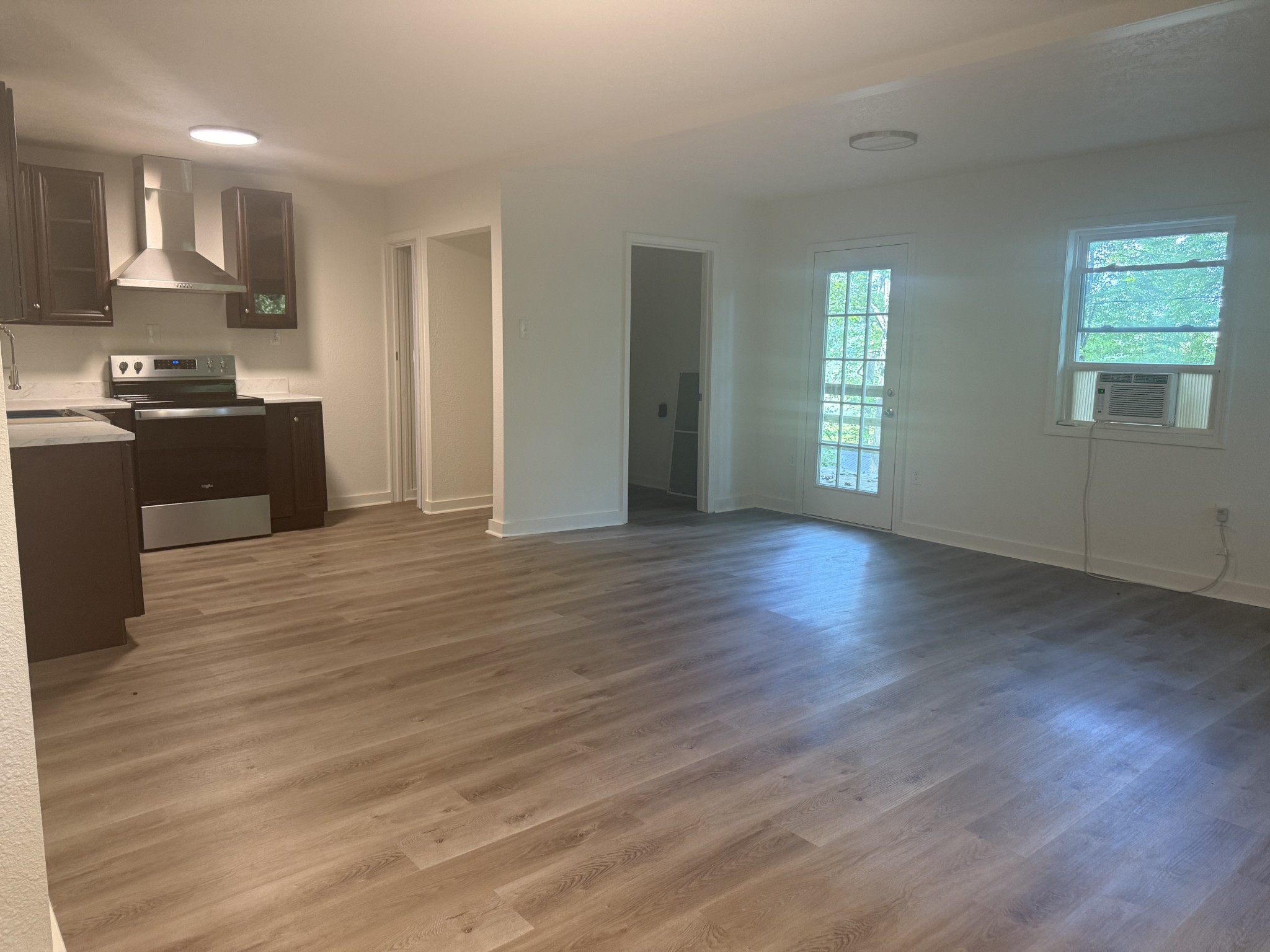 159 Hanklochte Drive Decaturville, TN 38329 - Photo 16 of 39 a kitchen with granite countertop wooden floors and wide window