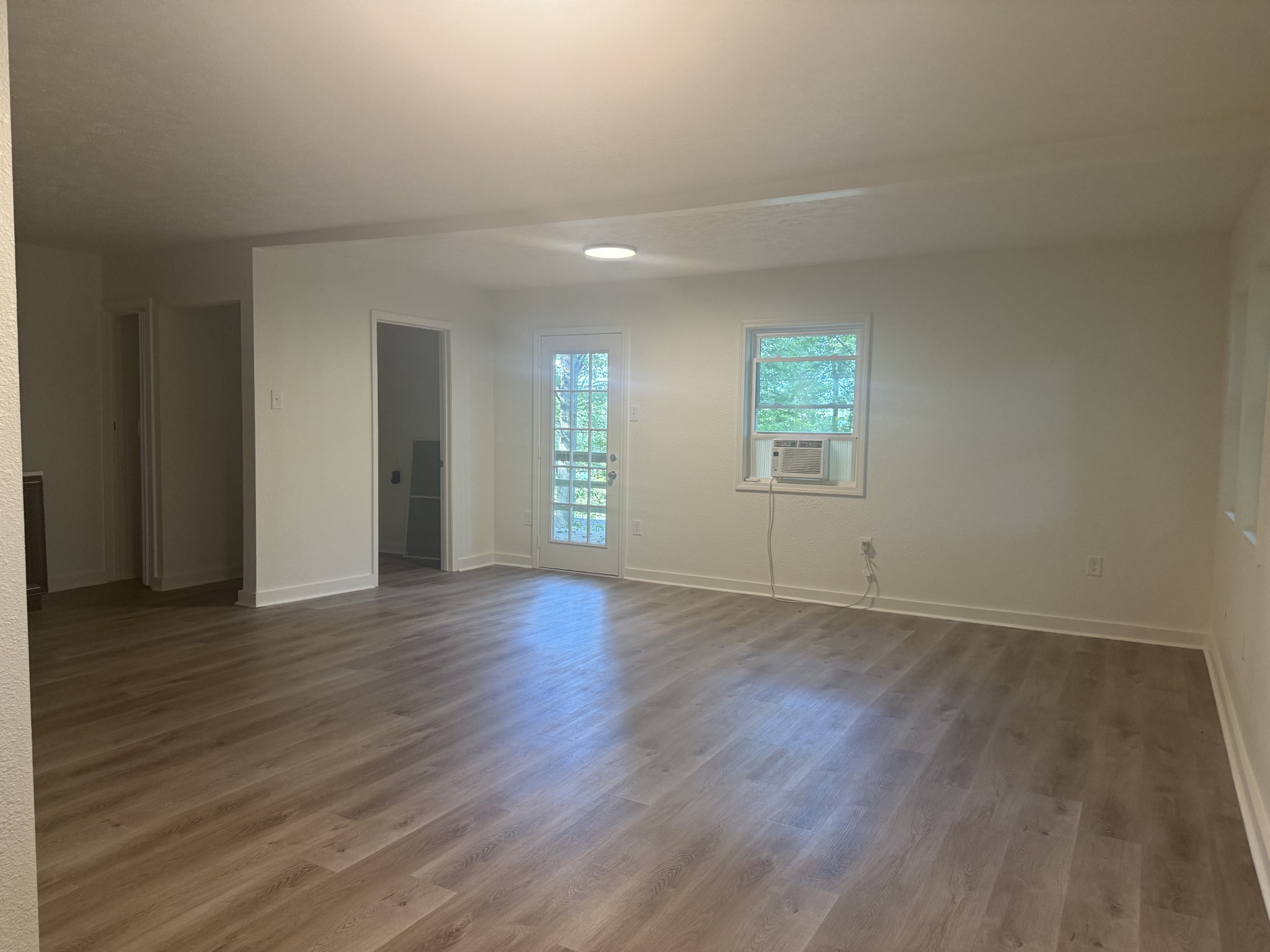 159 Hanklochte Drive Decaturville, TN 38329 - Photo 17 of 39 an empty room with wooden floor and windows