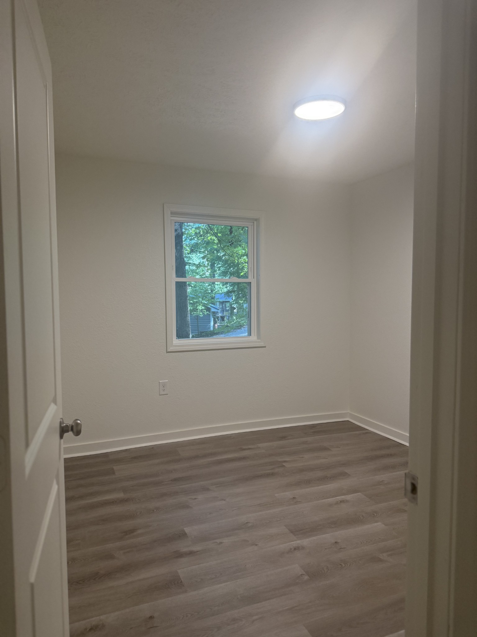 159 Hanklochte Drive Decaturville, TN 38329 - Photo 29 of 39 an empty room with wooden floor and windows
