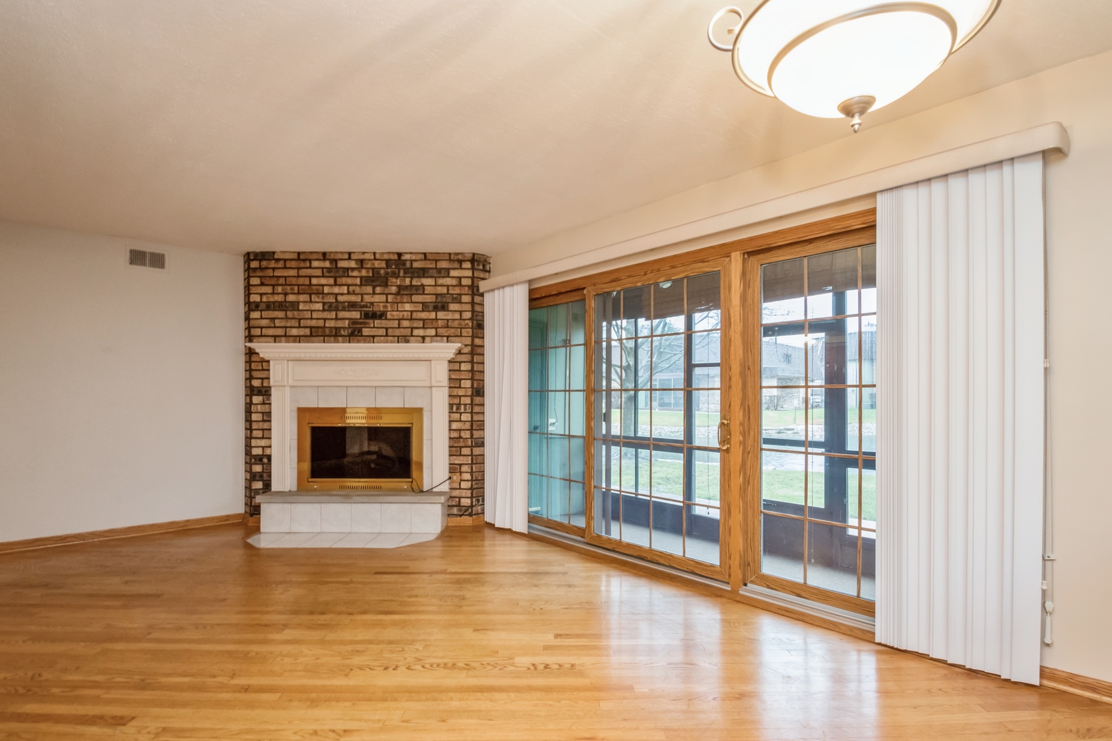 11136 NW Road, Unit B Palos Hills, IL 60465 - Photo 4 of 23 a view of an empty room with wooden floor and a window