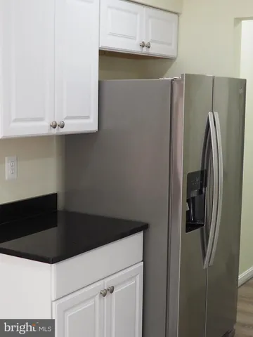 a kitchen with stainless steel appliances a refrigerator and cabinets