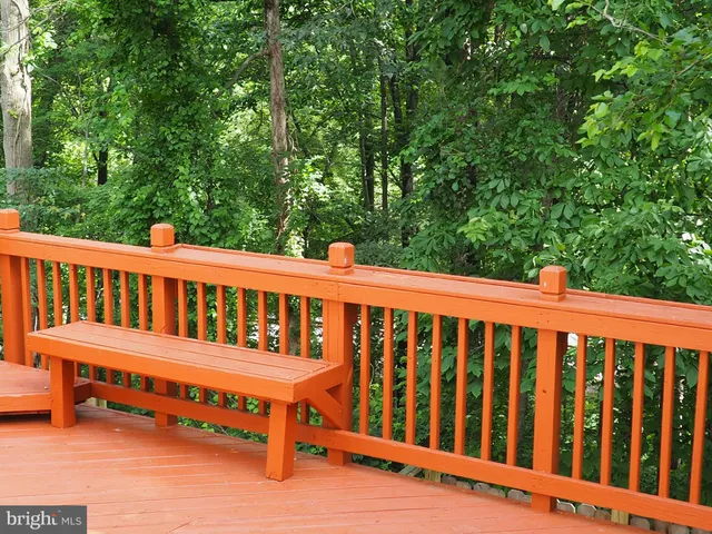 a view of a wooden bench and a small yard