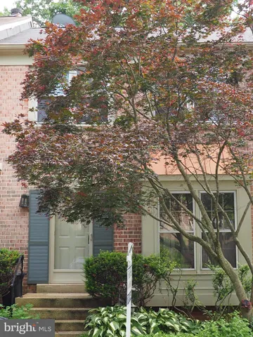 a front view of a house with trees