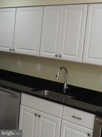 a close view of sink and cabinets
