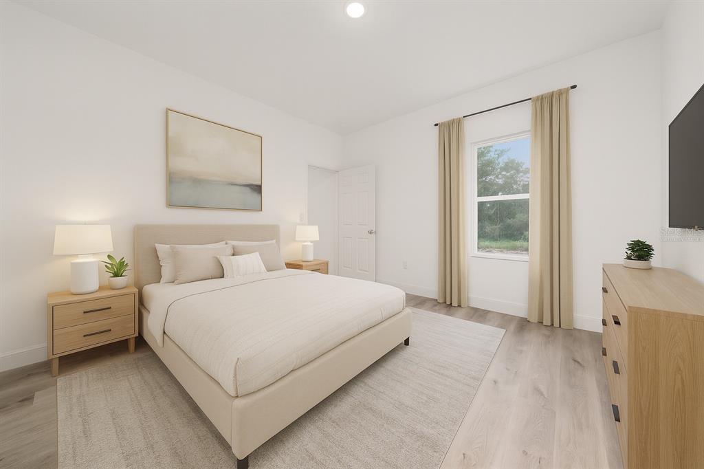 8922 Southwest 135th Street Road Ocala, FL 34473 - Photo 15 of 44 a bedroom with a bed and a window