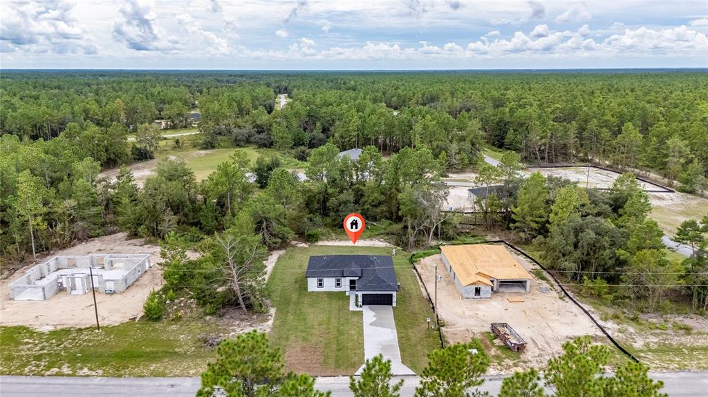 8922 Southwest 135th Street Road Ocala, FL 34473 - Photo 2 of 44 an aerial view of residential house with outdoor space and garden