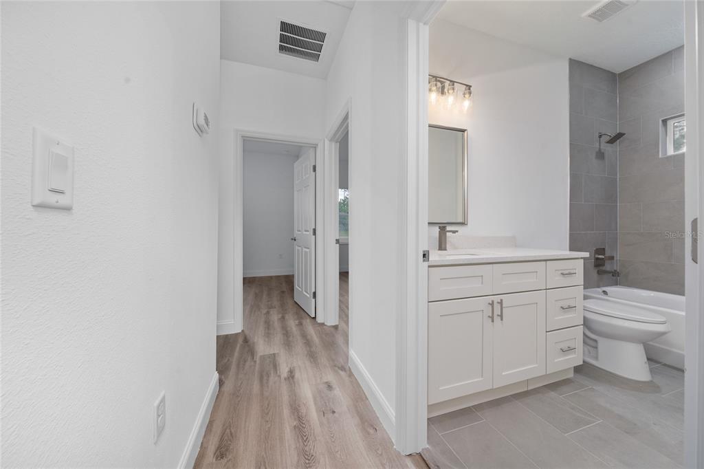 8922 Southwest 135th Street Road Ocala, FL 34473 - Photo 21 of 44 a bathroom with a sink a toilet and shower