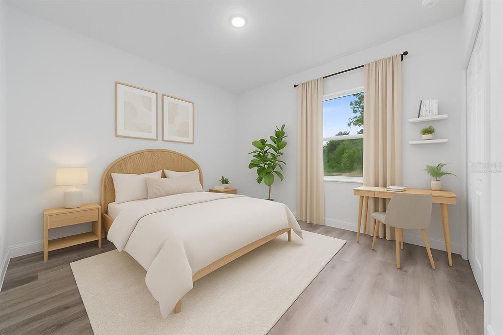 8922 Southwest 135th Street Road Ocala, FL 34473 - Photo 22 of 44 a bedroom with a large bed and a window