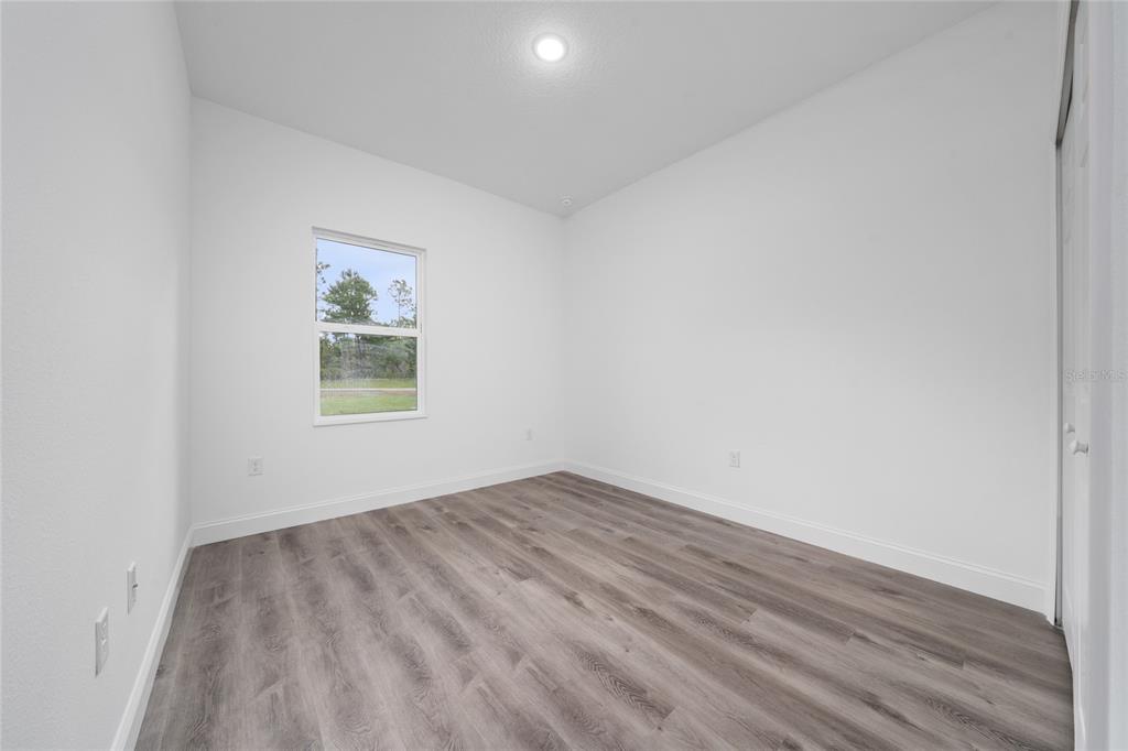 8922 Southwest 135th Street Road Ocala, FL 34473 - Photo 25 of 44 an empty room with a window
