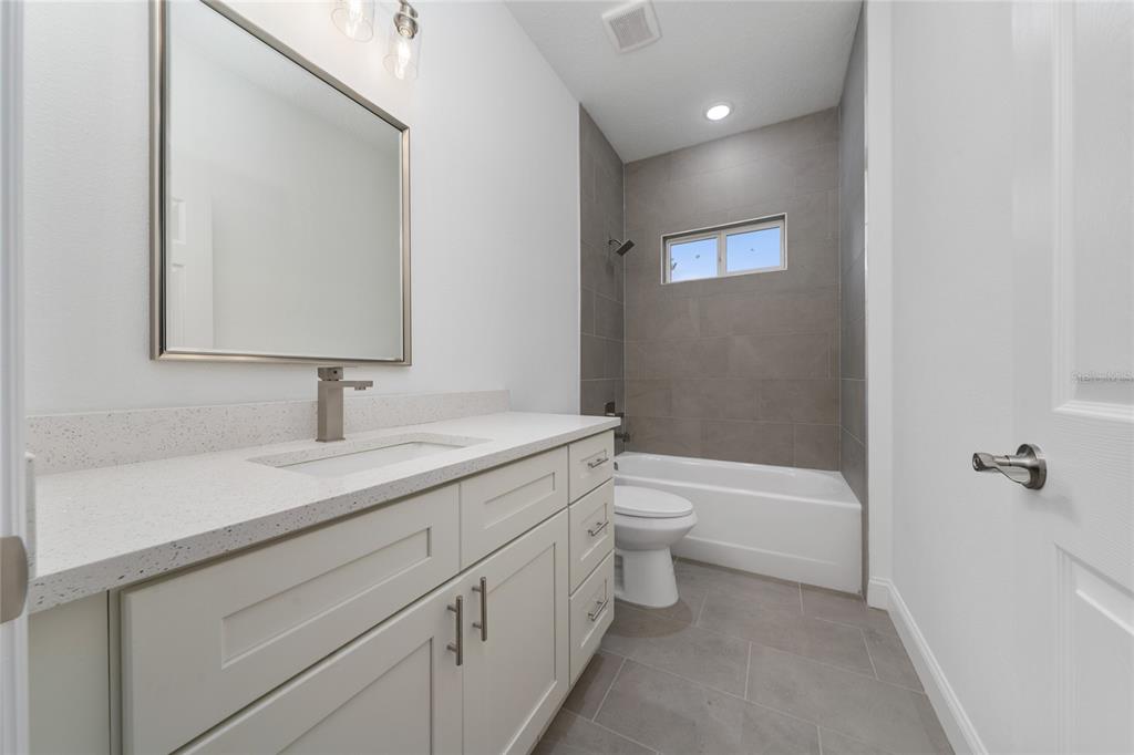8922 Southwest 135th Street Road Ocala, FL 34473 - Photo 30 of 44 a bathroom with a sink a toilet and shower