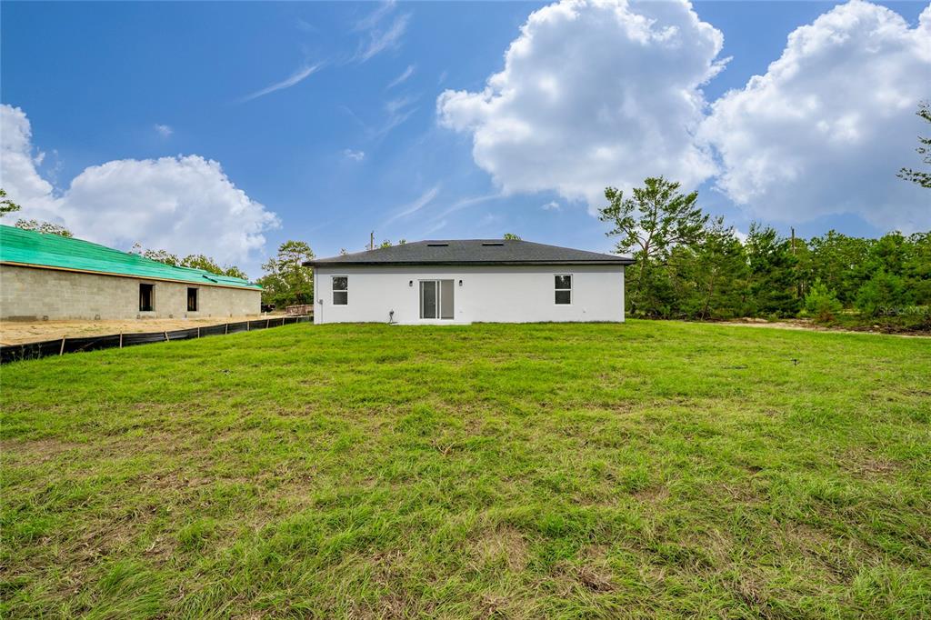 8922 Southwest 135th Street Road Ocala, FL 34473 - Photo 35 of 44 a house view with garden space and trees