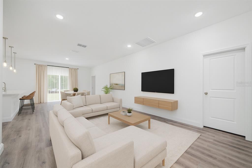 8922 Southwest 135th Street Road Ocala, FL 34473 - Photo 6 of 44 a living room with furniture and a flat screen tv