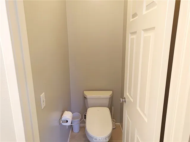 a bathroom with a toilet and a mirror