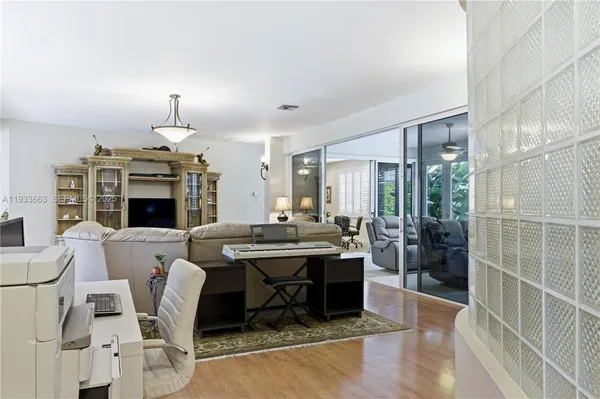 a living room with furniture a fireplace and a chandelier