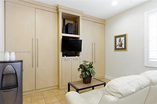 a living room with furniture and a potted plant