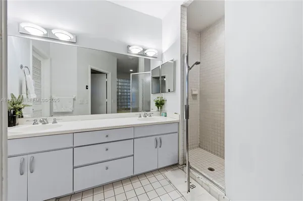 a bathroom with a double vanity sink mirror and double