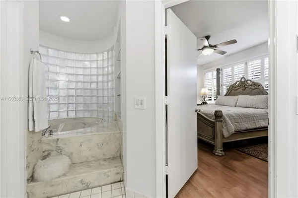 a en suite bathroom with a tub shower and sink