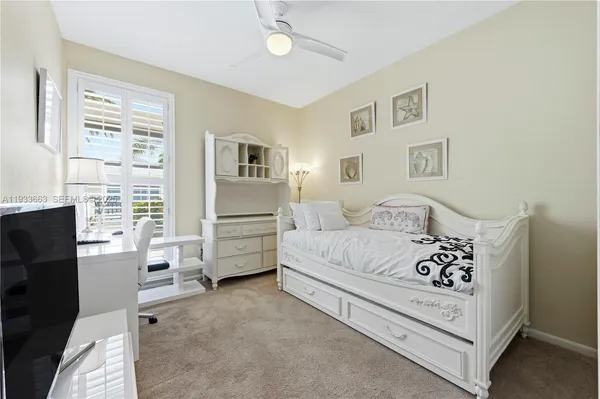 a bedroom with a bed and a television