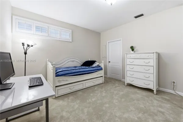 a bedroom with furniture and a table