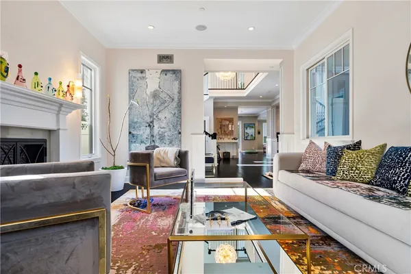 a living room with furniture fireplace and a table
