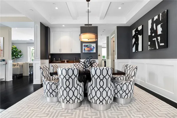 a view of furniture and dining room with wooden floor